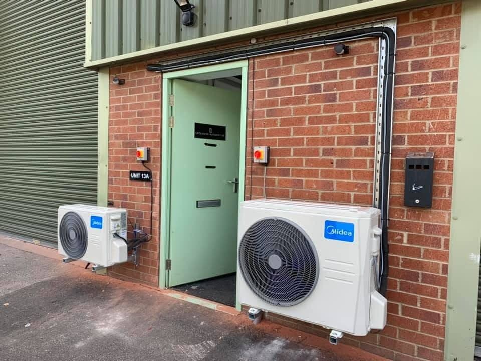 Pair of air conditioning condensers outside a commercial unit