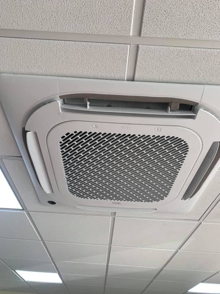Ceiling cassette air conditioning unit set into a suspended ceiling grid