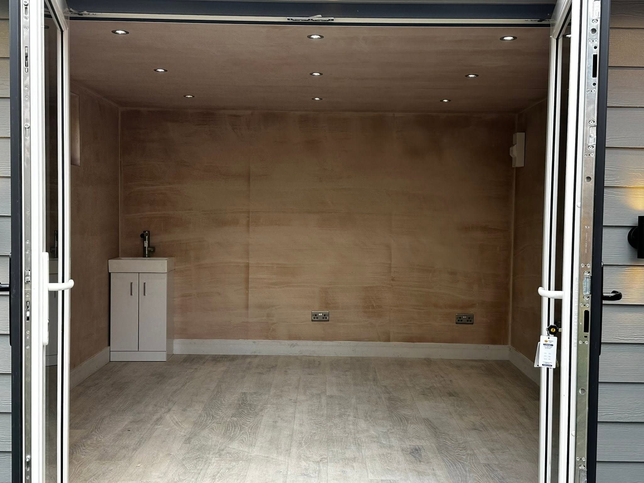 Garden room interior with downlights and open bifold doors