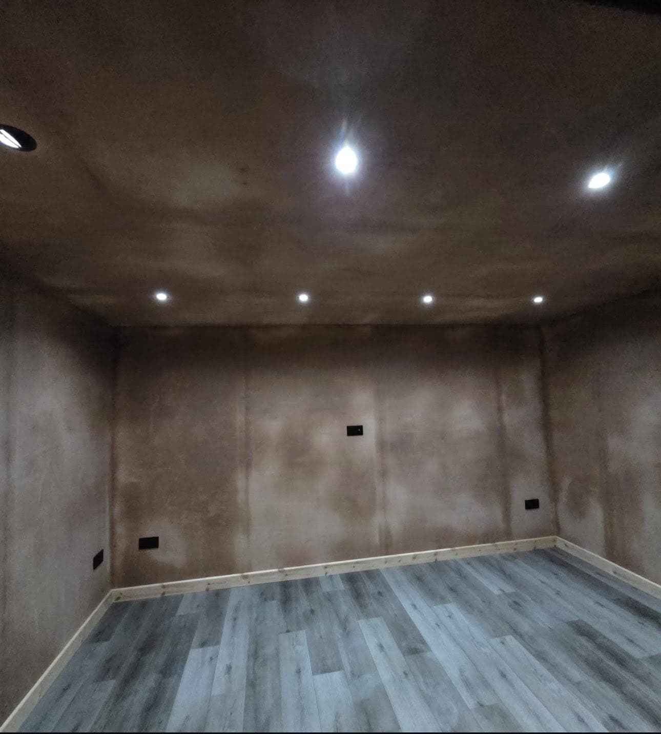 Newly plastered room with a hanging pendant light