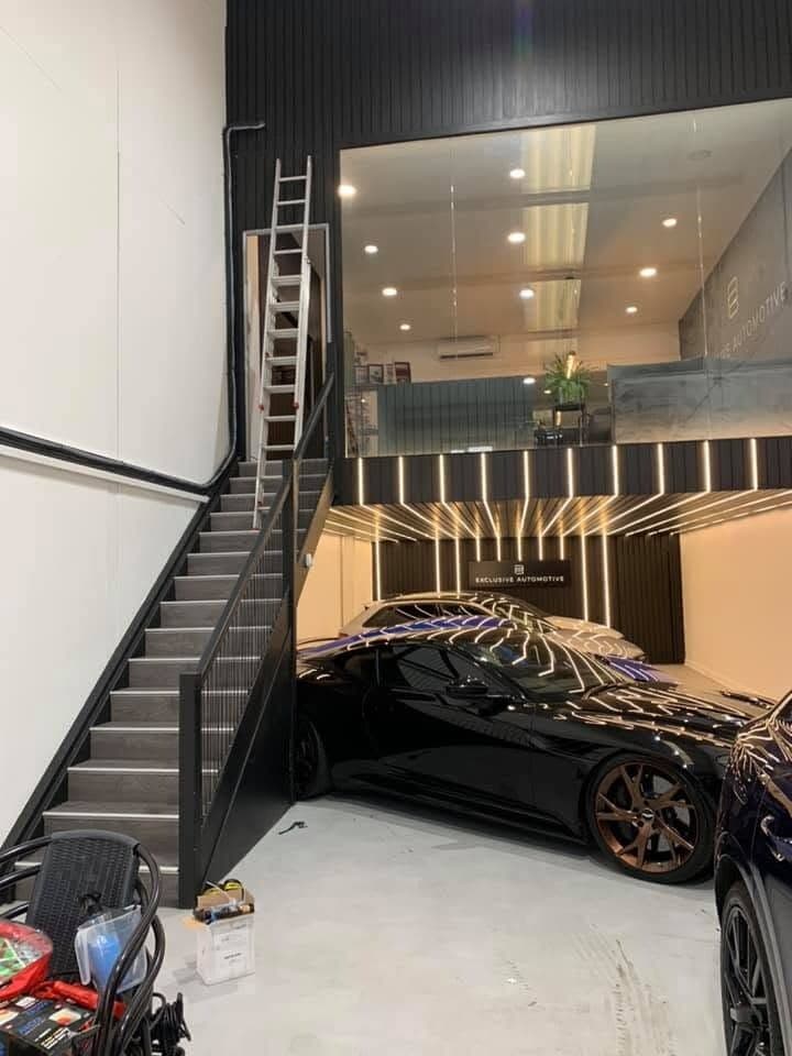 Car showroom with feature staircase lighting and recessed ceiling downlights