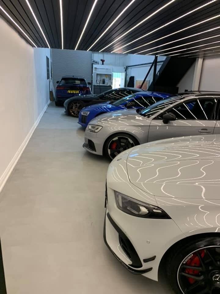 Showroom floor lit by a run of linear ceiling lighting